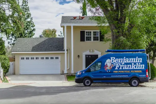 A Benjamin Franklin Plumbing Van in front of a home in Lakeland FL