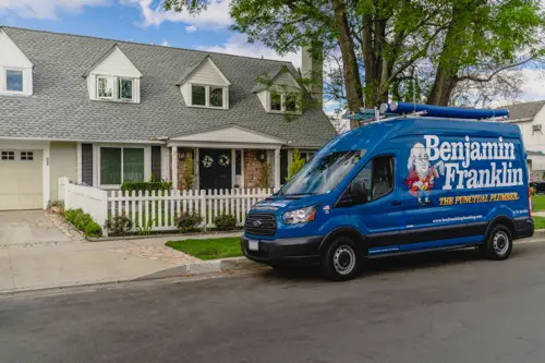 Benjamin Franklin Plumbing Van in front of house getting ready for a service call